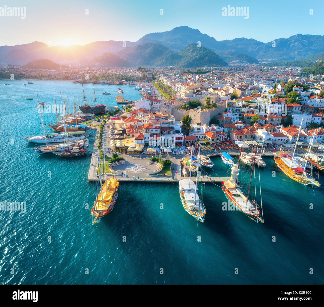 Vista aerea di barche e una splendida architettura al tramonto a Marmaris, Turchia. colorato paesaggio con barche in marina bay, mare, città, montagne. top Foto Stock
