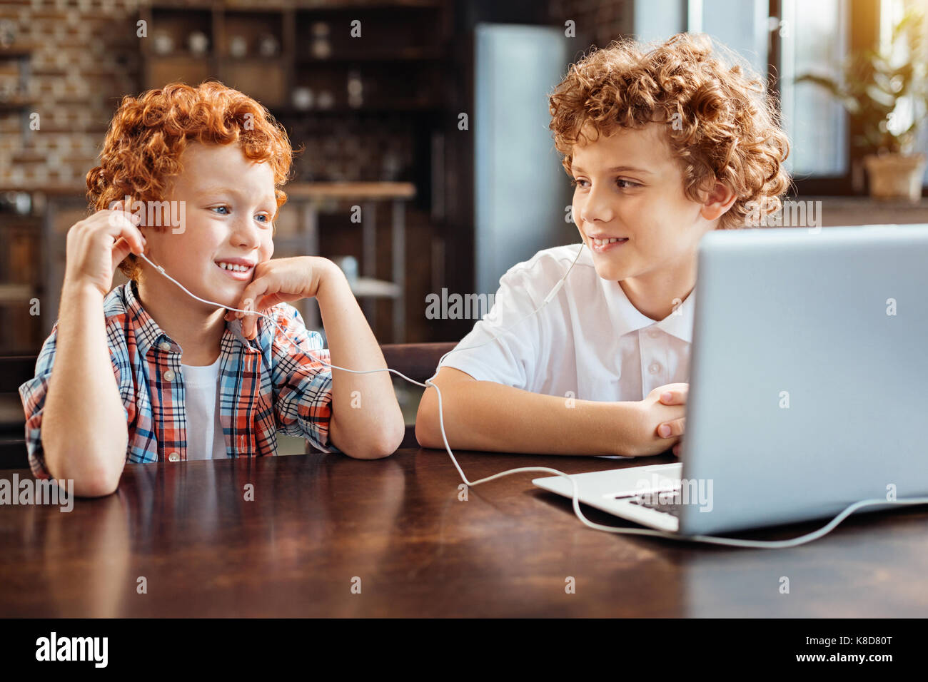 Rilassata redhead bambini ascolto di musica a tavola Foto Stock