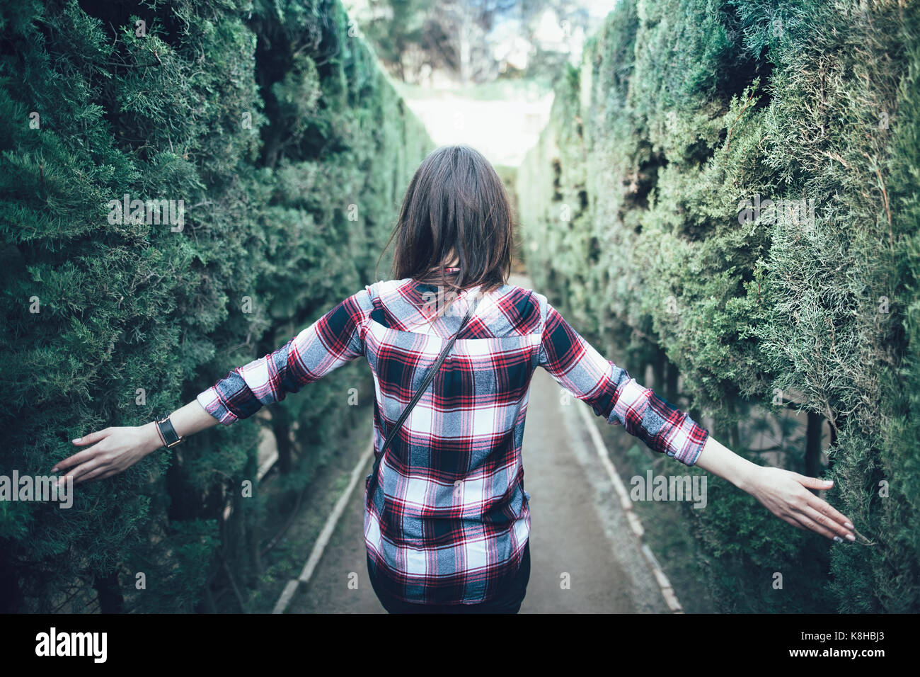Giovane donna camminare nel parco labirinto in Barcelona Foto Stock