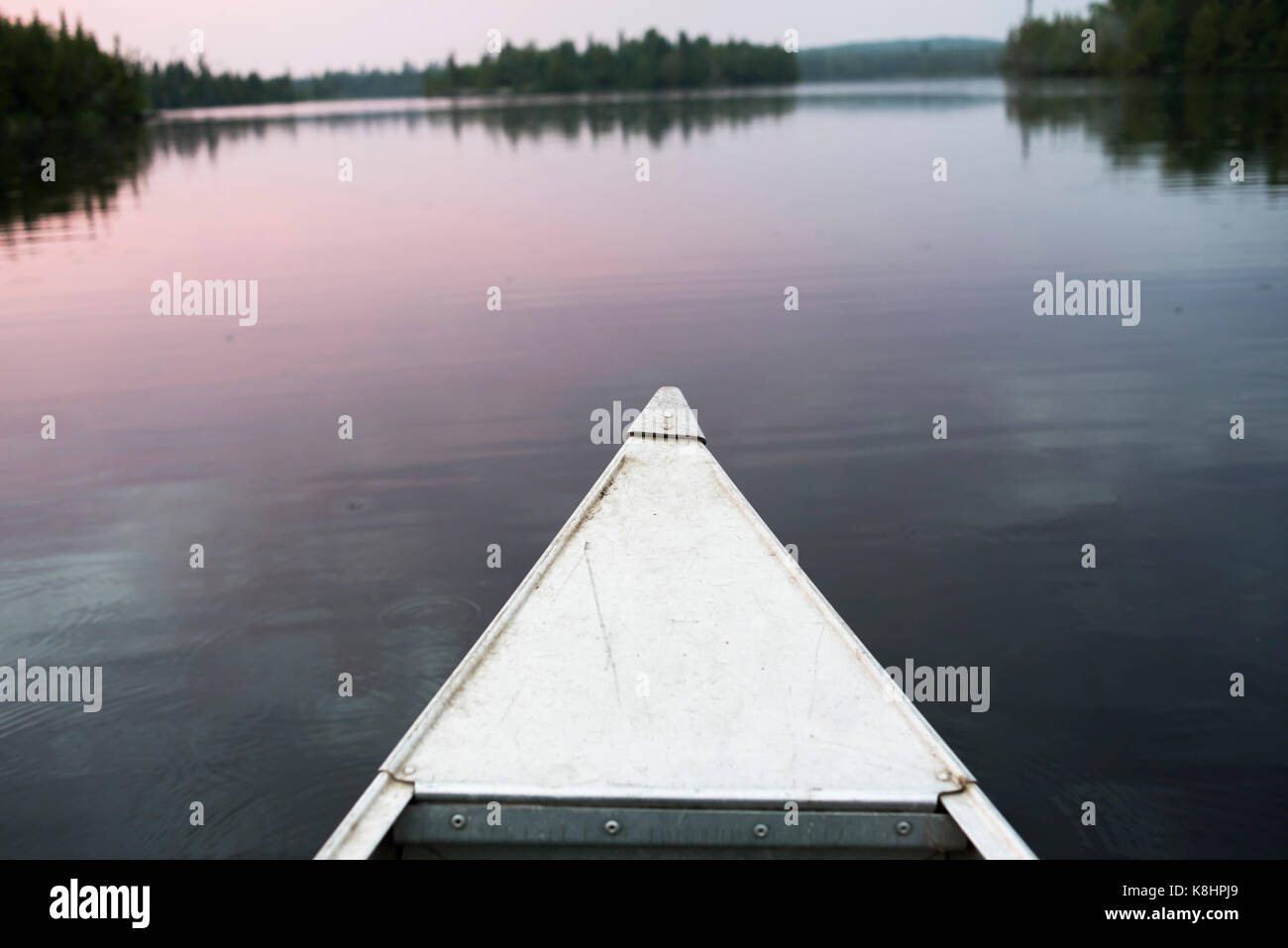 Nave di prua sul lago durante il tramonto Foto Stock