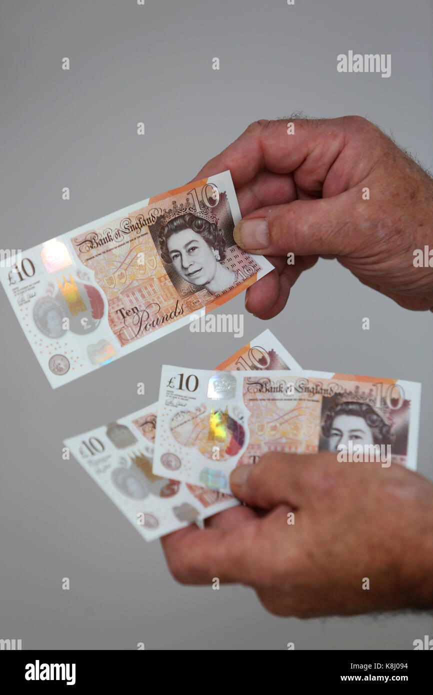 Un uomo nella foto tenendo un nuovo dieci pound nota nella sua casa a Chichester, west sussex, Regno Unito. Foto Stock