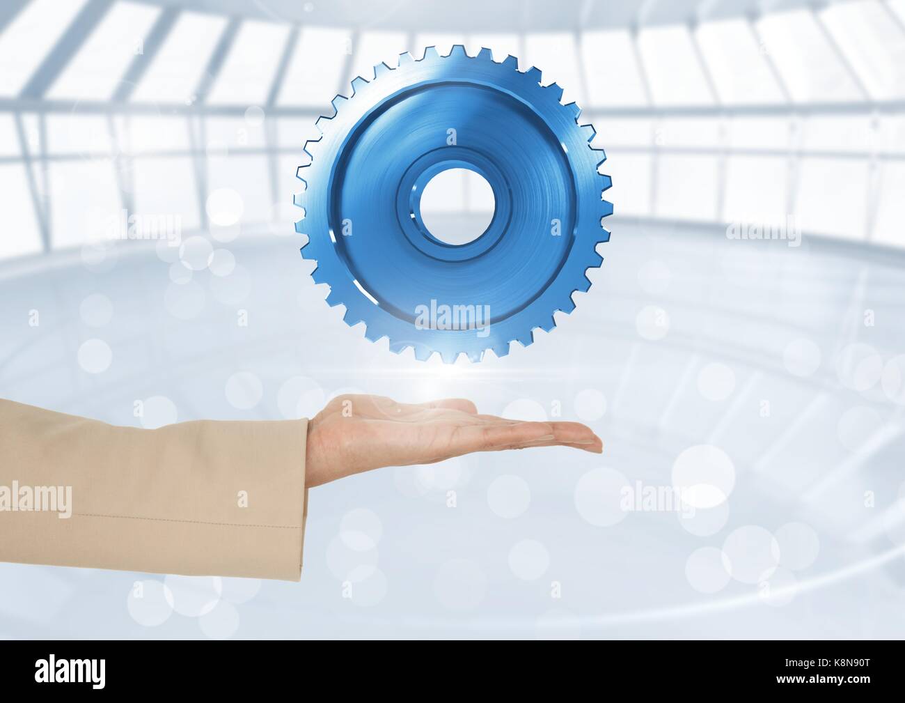 Composito Digitale della mano aperta azienda dente ingranaggio Foto Stock
