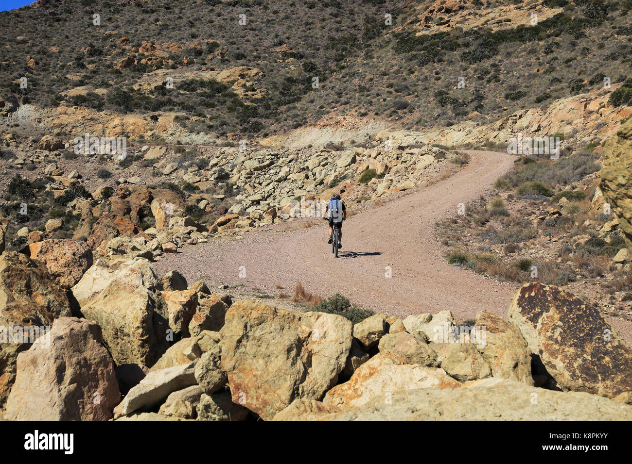 Persona in bicicletta nel Parco Nazionale Cabo de Gata, Monsul, nei pressi di San José, Almeria, Spagna Foto Stock