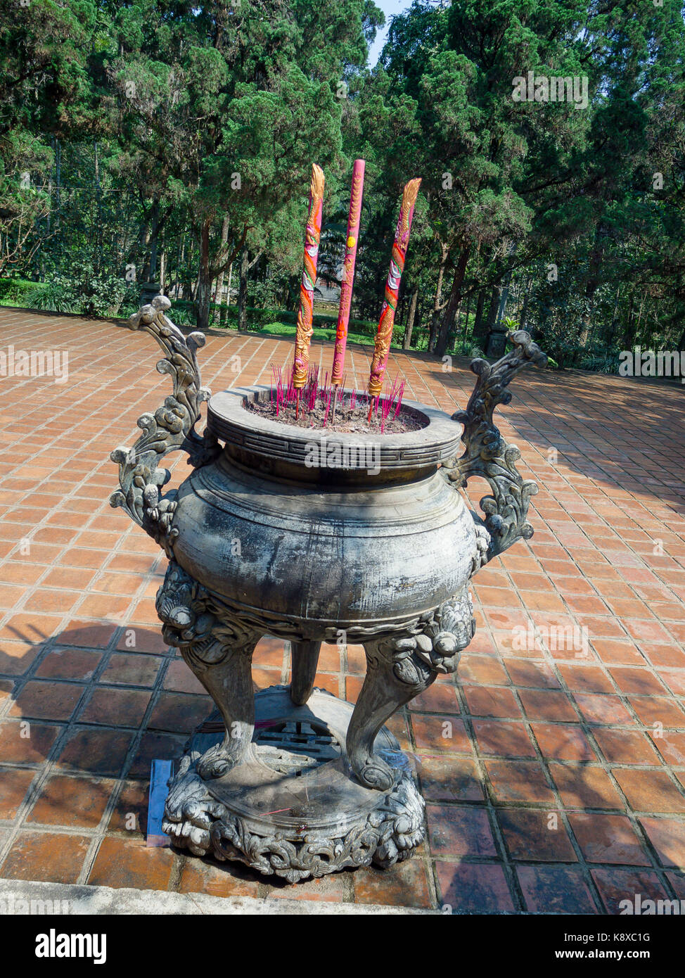 Close up incensa bruciare in un tempio buddista all'interno di un enorme pentola in un patio di un tempio di hue in Vietnam Foto Stock