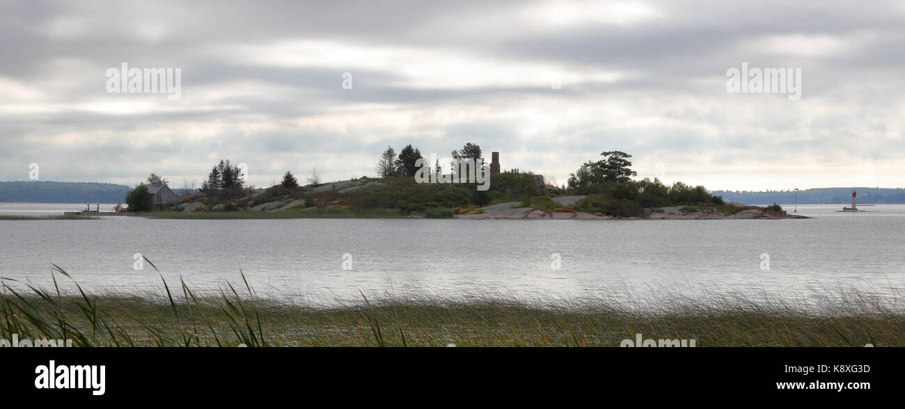 Un isola rocciosa sulla st Lawrence river om un giorno nuvoloso Foto Stock