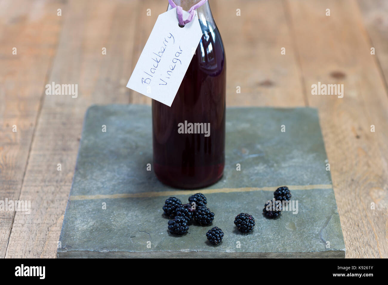 In casa di aceto di blackberry su una scheda di ardesia. Foto Stock