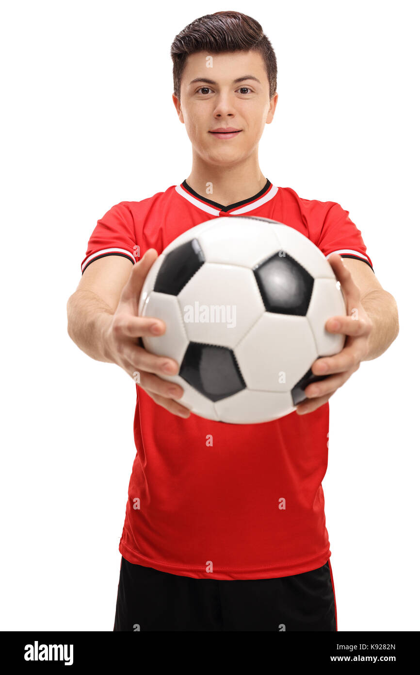 Teenage giocatore di calcio dare un calcio isolati su sfondo bianco Foto Stock