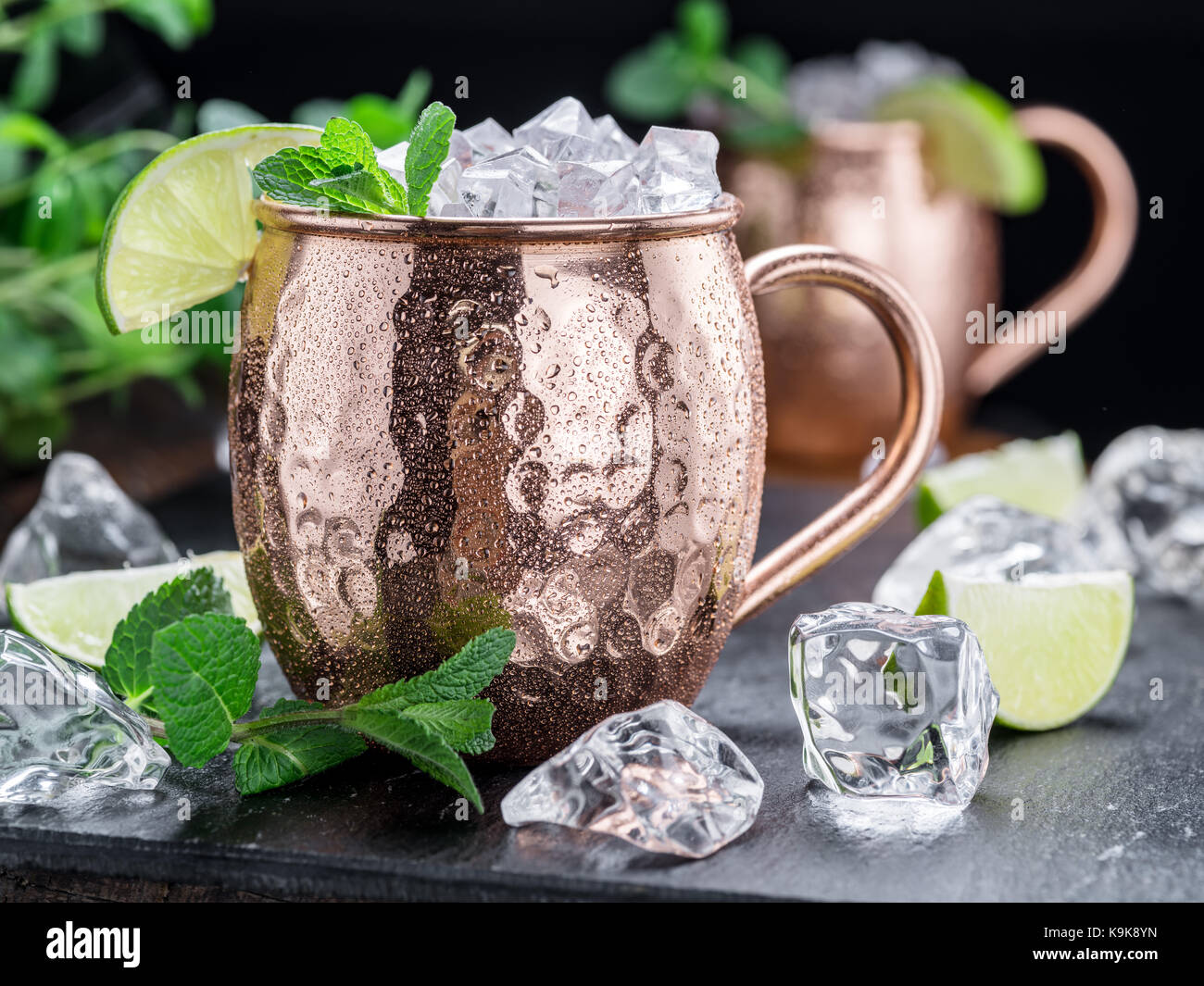Moscow mule. frosty mug in rame con calce e cubetti di ghiaccio sul tavolo. Foto Stock