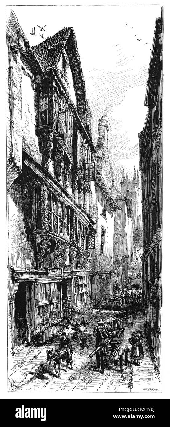 1870: una via di mezzo in legno in stile tudor edifici in Dartmouth impostato sulla sponda occidentale dell' estuario del fiume Dart, Devon, Inghilterra Foto Stock
