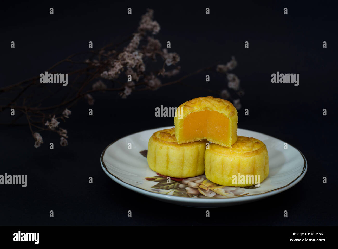 Cinese tradizionale metà autunno festival la torta della luna con crema pasticcera ripieno su sfondo nero Foto Stock