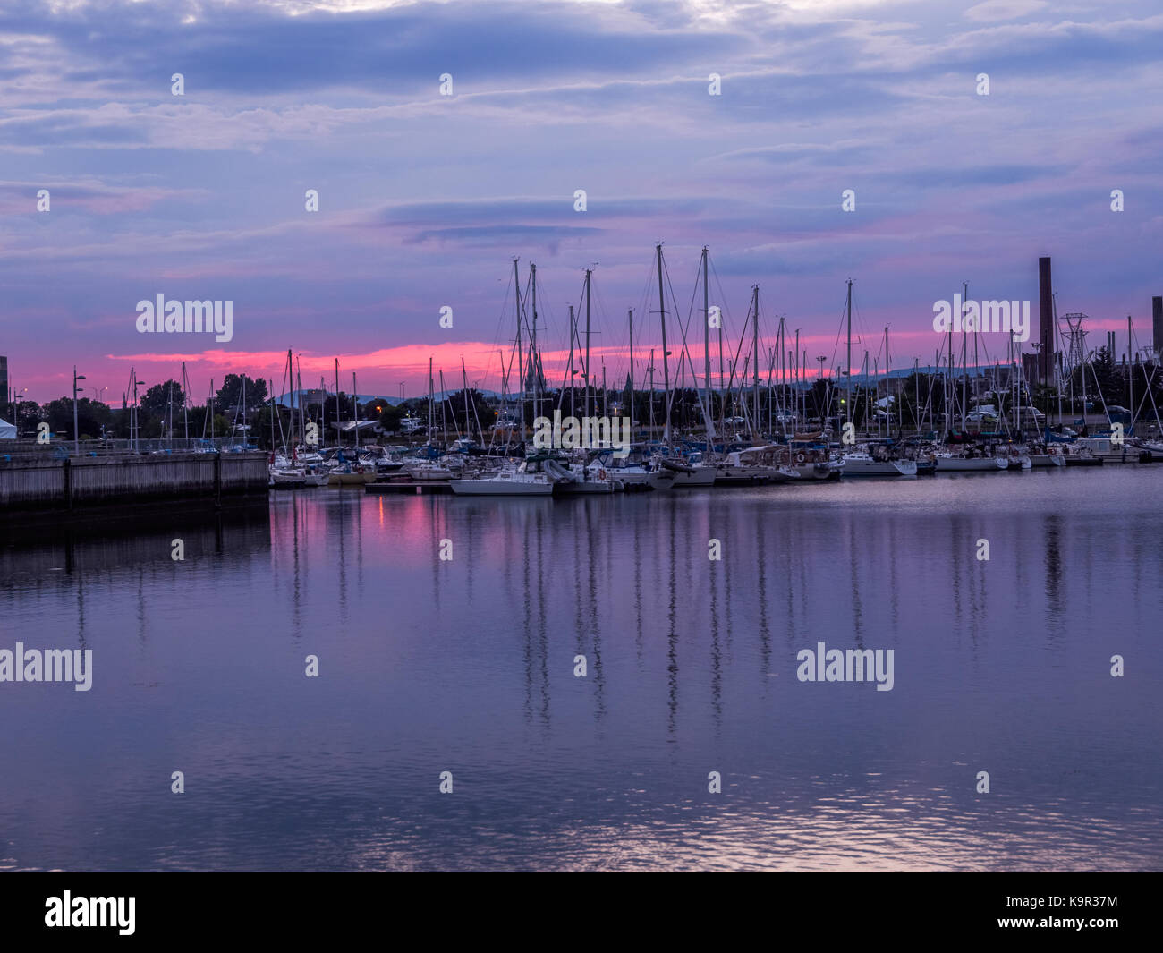 Bel tramonto durante le estati a Quai Saint-André, Ville de Québec, QC che mostra le barche con straordinaria riflessione e cielo incandescente Foto Stock