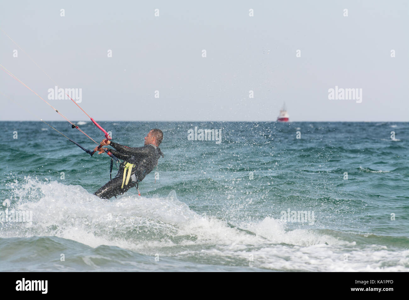 Kitesurfer surf a seawaves Foto Stock