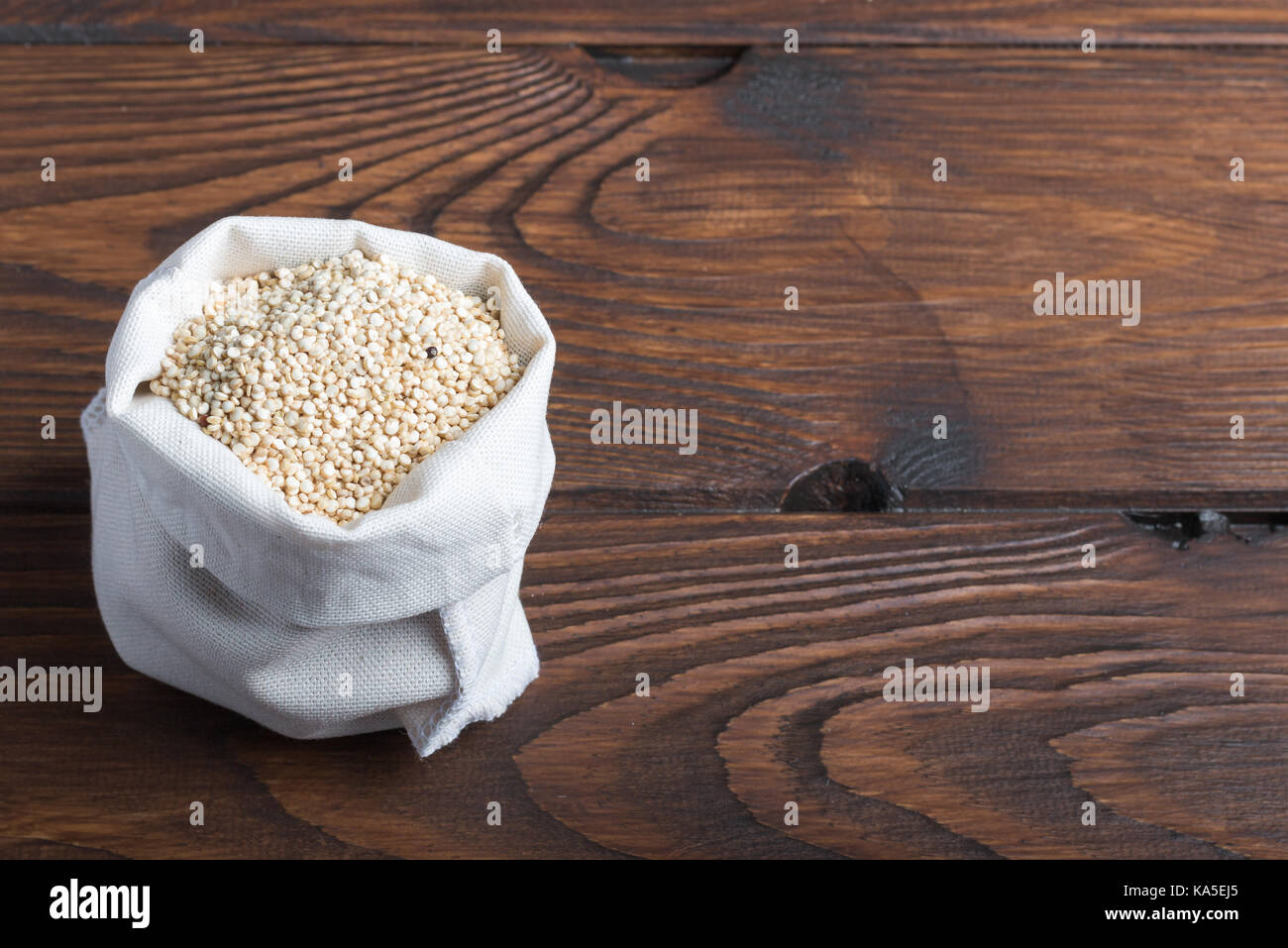 Sac del bio quinoa su una tavola di legno Foto Stock
