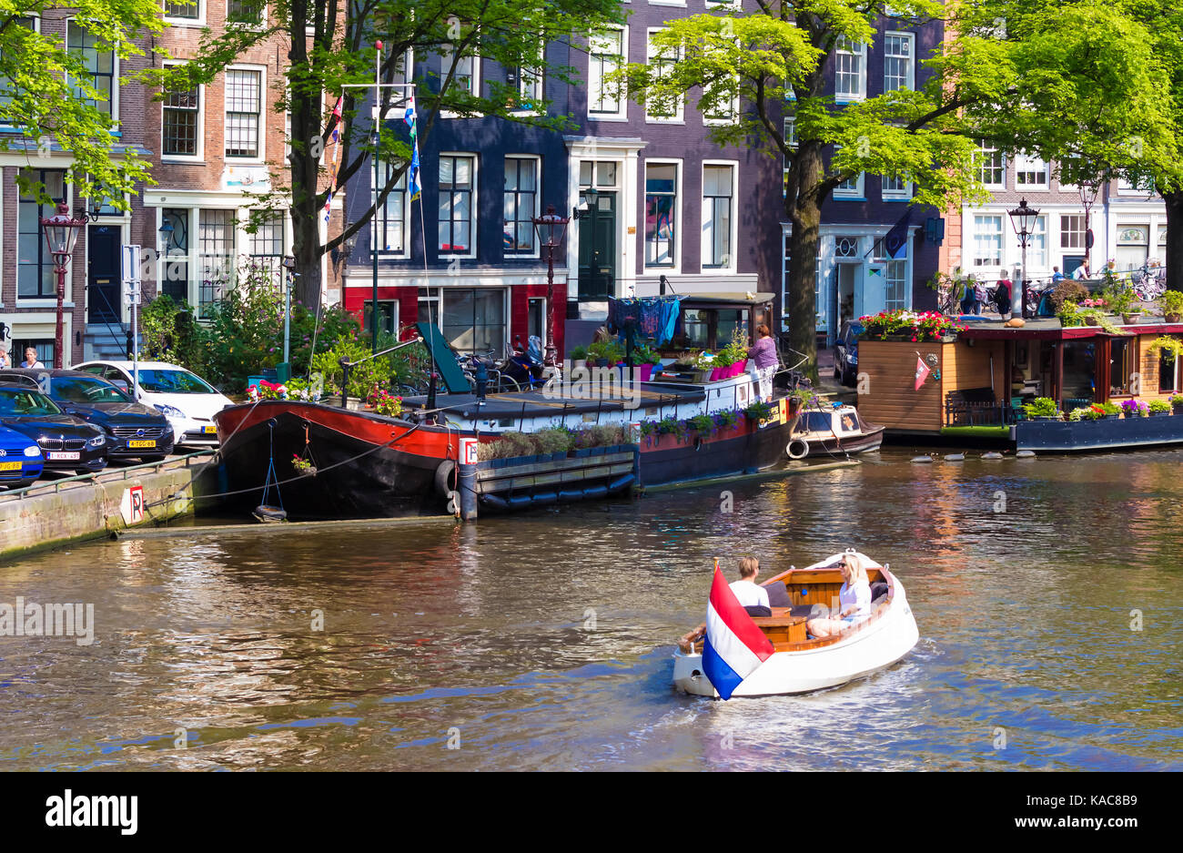 Persone Viaggi in battello lungo i canali di Amsterdam durante l'estate. Foto Stock