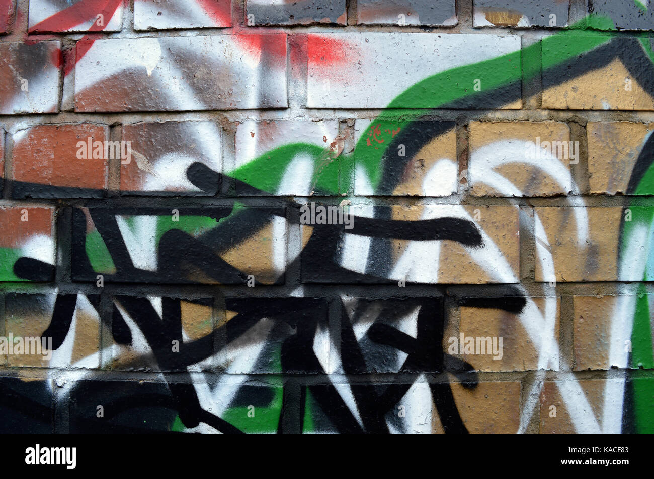 Un muro di graffiti scrawled Foto Stock