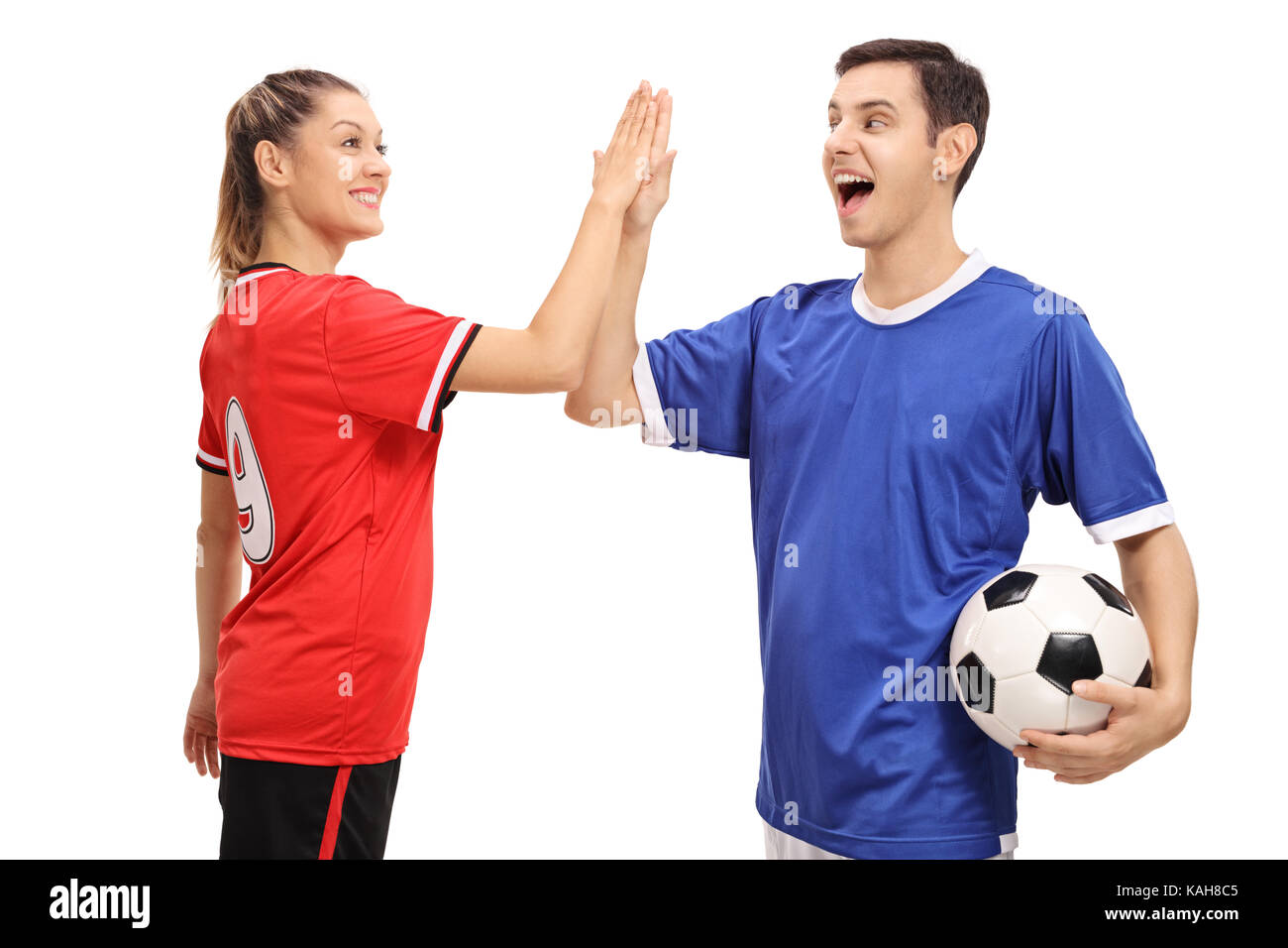 Femmina e un maschio di giocatore di calcio ad alta fiving reciprocamente isolati su sfondo bianco Foto Stock