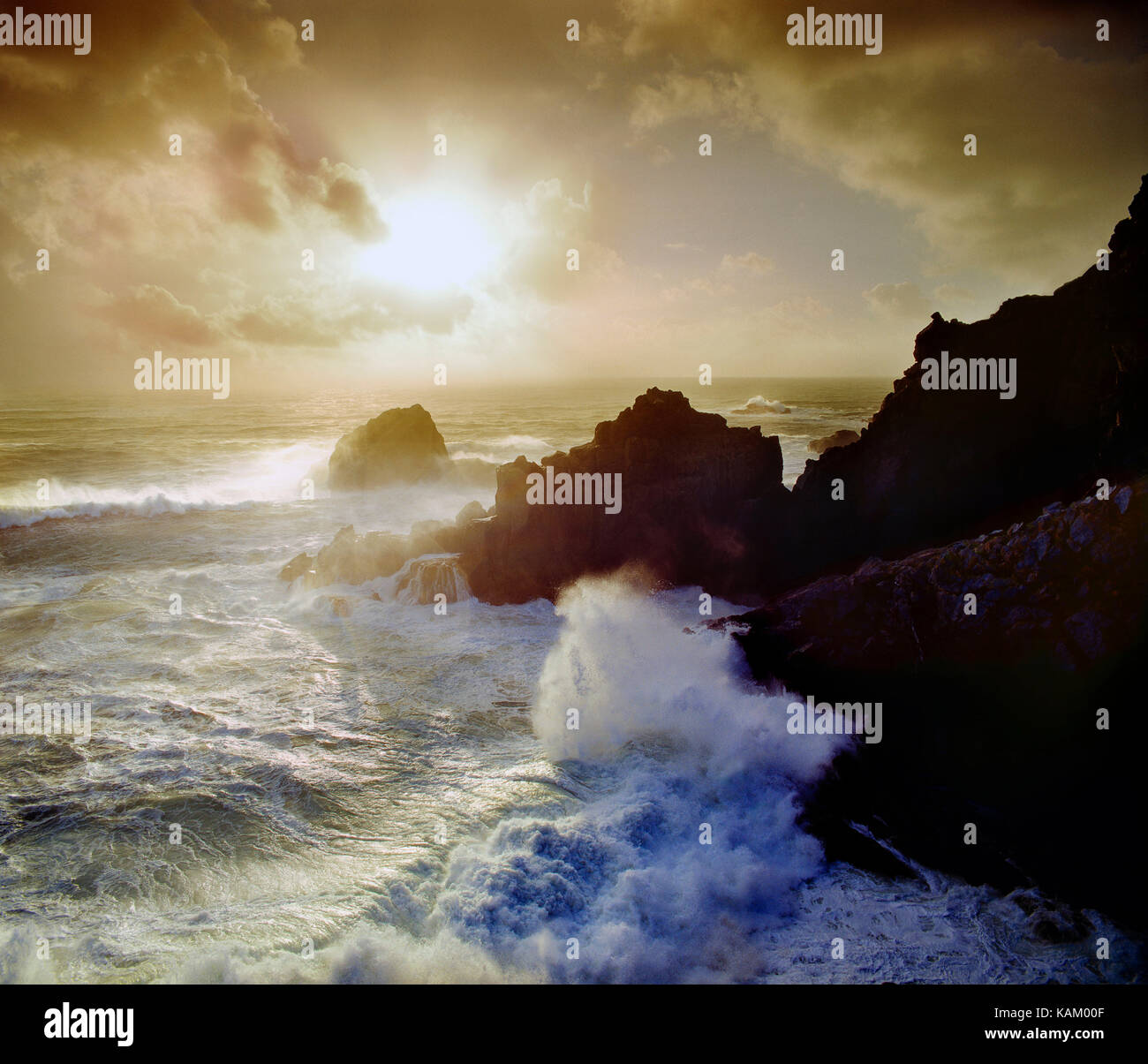Isole del Canale. Guernsey. Punto Pleinmont. Surf sulle rocce al tramonto. Foto Stock