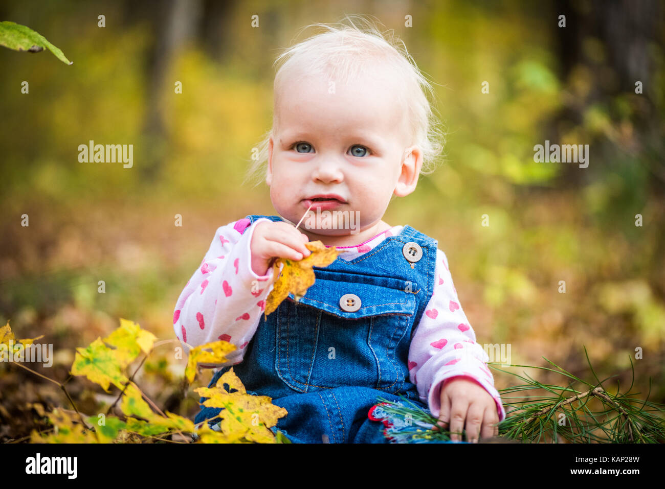 Felice piccolo bambino, Baby girl ridendo e giocando in autunno sulla foresta Foto Stock