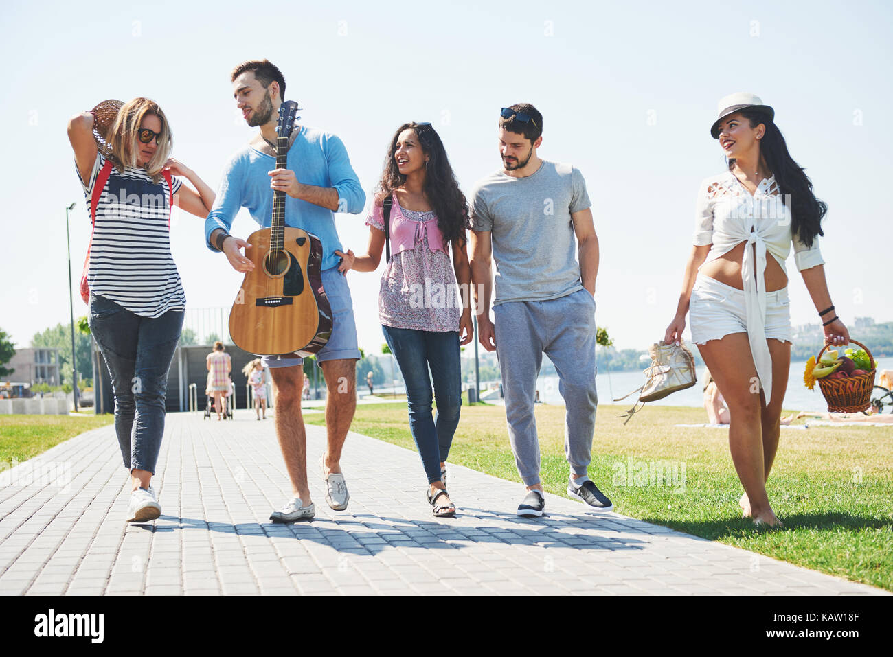 Ritratto di gruppo di amici andando sulla spiaggia. gruppo misto di amici di camminare sulla spiaggia sul giorno di estate Foto Stock