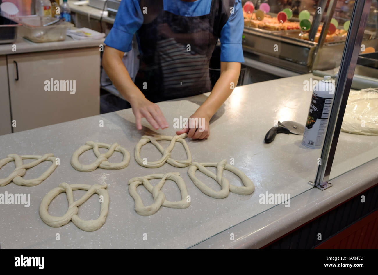 Amish rendendo un pretzel in Reading Terminal Market, Philadelphia, PA, Stati Uniti d'America Foto Stock