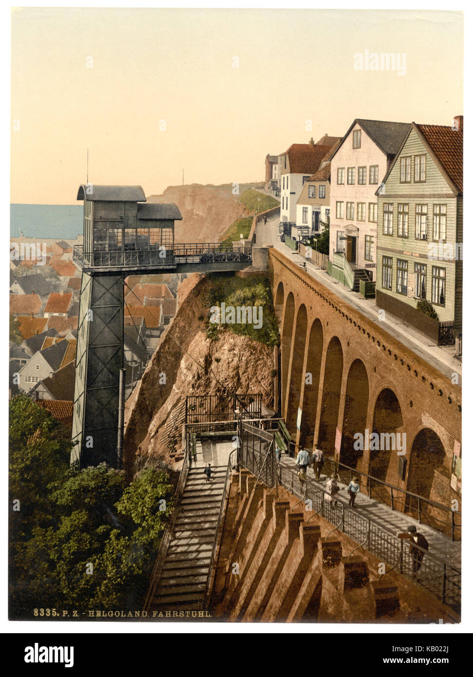 "L'ascensore" a Helgoland, in Germania, è una fotografia storica che raffigura il sistema di ascensori utilizzato per trasportare le persone tra il porto dell'isola e le scogliere superiori, mostrando l'ingegneria tedesca dell'inizio del XX secolo. Foto Stock