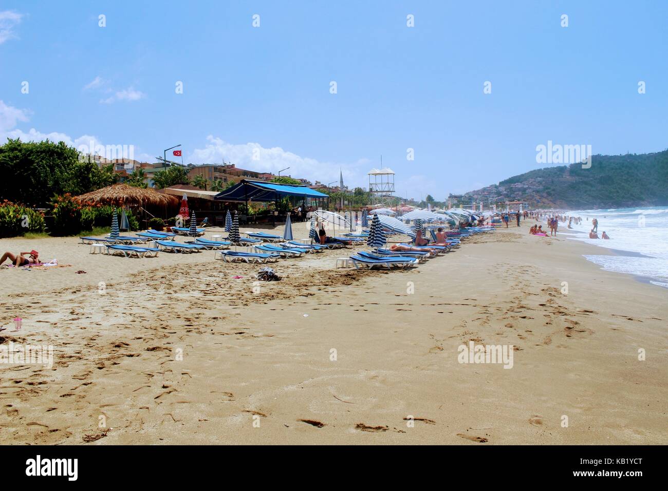 Luglio, 2017 - persone appoggiano sulle sedie a sdraio all'ombra di ombrelloni sulla spiaggia di cleopatra (Alanya, Turchia). Foto Stock