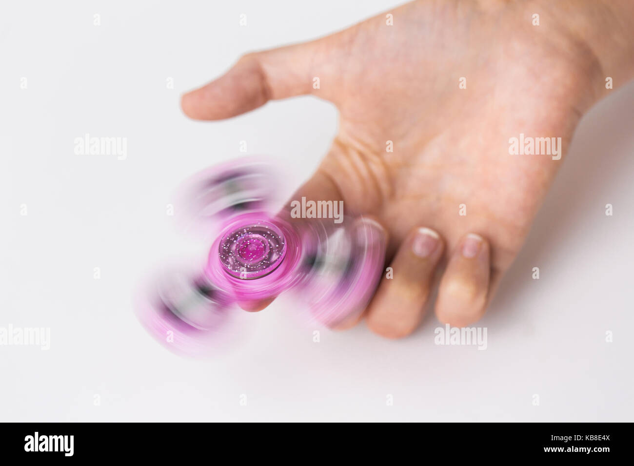 Stretta di mano giocando con agitano: spinner Foto Stock