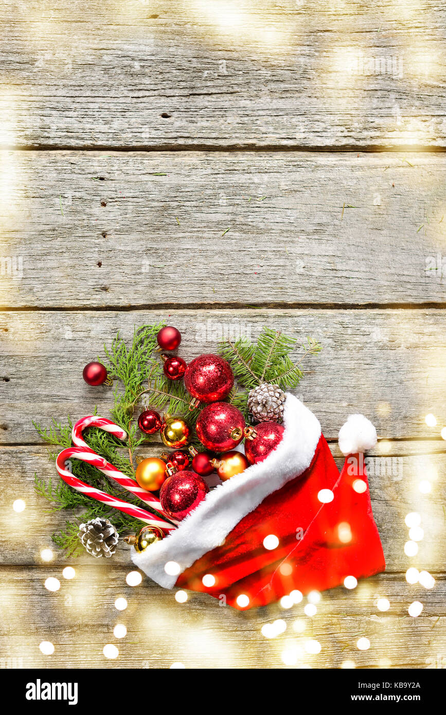 Rosso di Babbo Natale con cappello di Natale composizione sfere,  giocattoli, candy, Abete rami su vintage in legno copia di sfondo spazio  luci di disegno Foto stock - Alamy