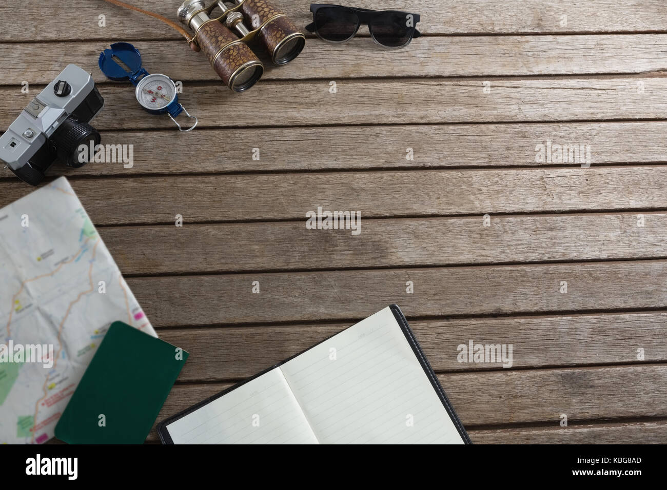 Sovraccarico di accessori da viaggio su tavola in legno Foto Stock