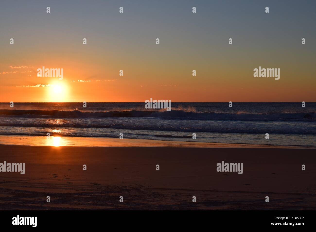 Tramonto sul mare con la riflessione del sole nell'acqua Foto Stock