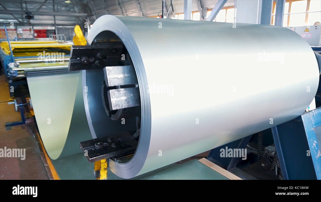 Acciaio laminato. pacco di rotoli di acciaio laminato a freddo bobine in azione. lamiera di acciaio galvanizzato e rusty rim. di acciaio laminato a freddo bobine. Egli tamburo gira i fogli metallici nella produzione industriale. Foto Stock