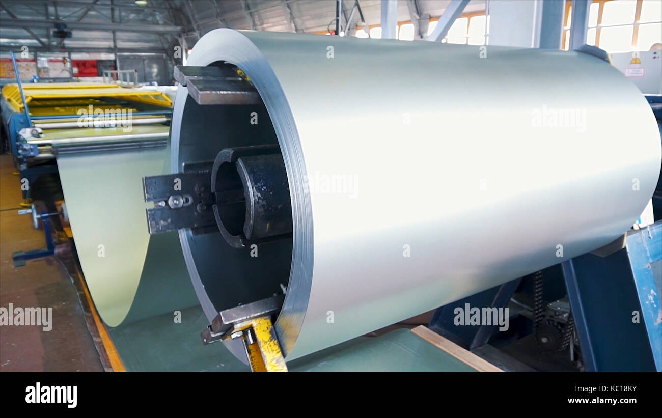 Acciaio laminato. pacco di rotoli di acciaio laminato a freddo bobine in azione. lamiera di acciaio galvanizzato e rusty rim. di acciaio laminato a freddo bobine. Egli tamburo gira i fogli metallici nella produzione industriale. Foto Stock