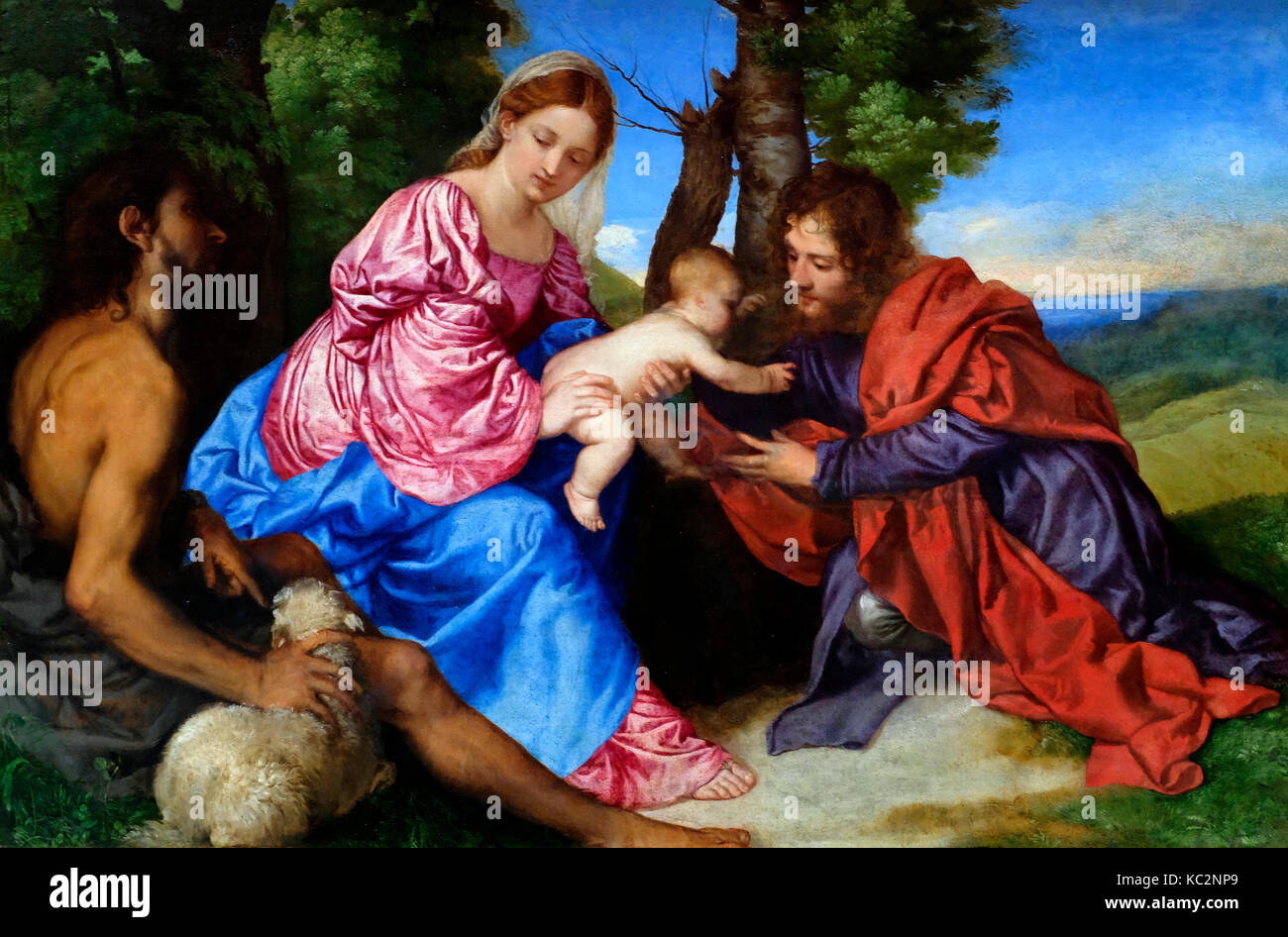 La Vergine e il bambino in un paesaggio con San Giovanni Battista e un altro santo maschio - Titian (Tiziano Vecellio), circa 1520 Foto Stock