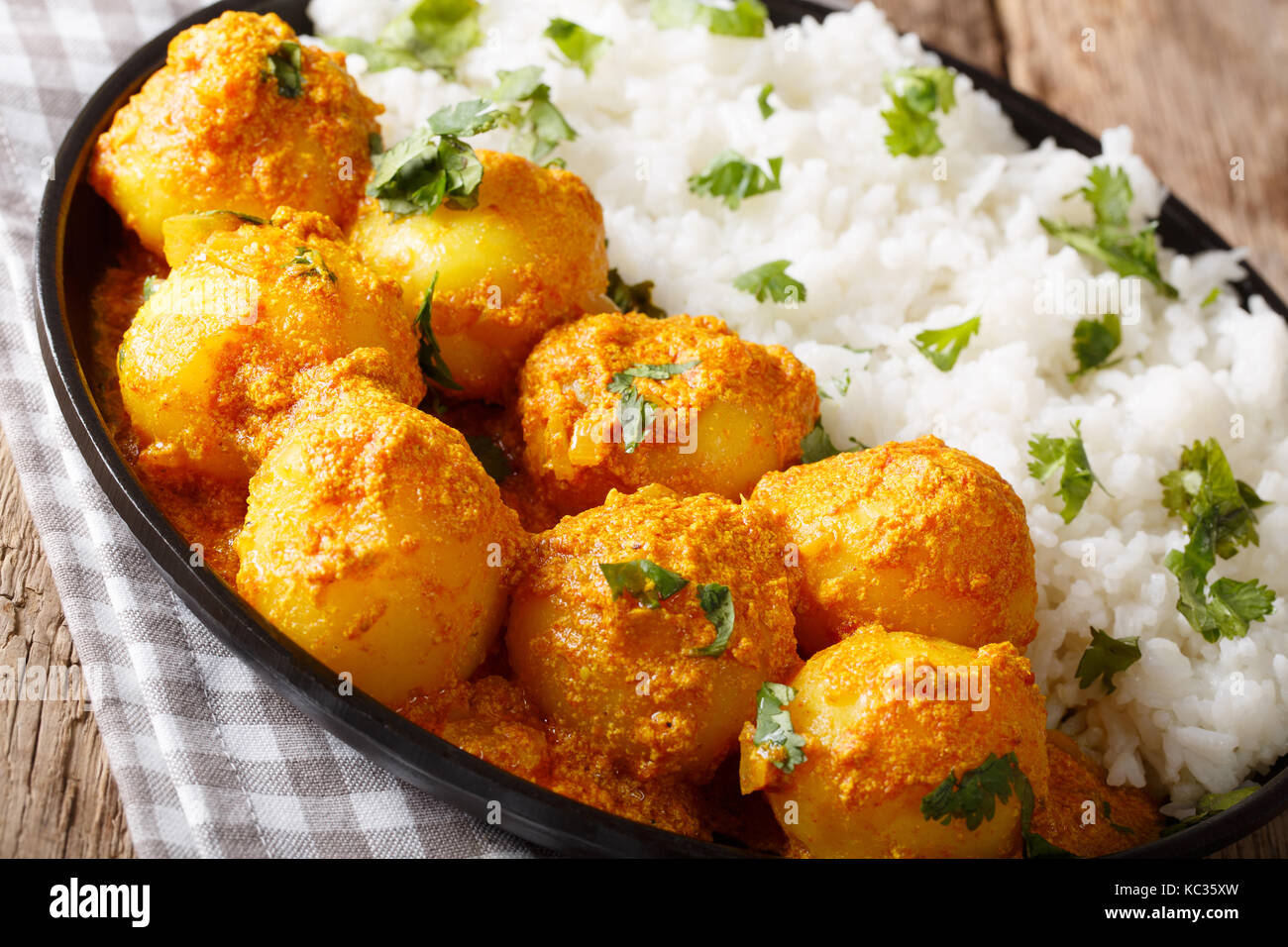 Dum del Kashmir, aloo: patate speziate con riso closeup sul piatto sul tavolo orizzontale. Foto Stock