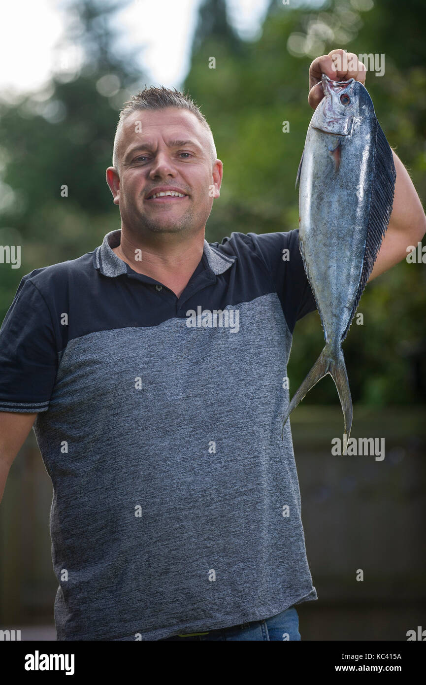 Il pescatore Mark Padfield che hanno catturato il primo registrato Dolphin pescare in acque britanniche, da Chesil Beach nel Dorset. Il pesce è non nativa per le acque del Regno Unito. Foto Stock