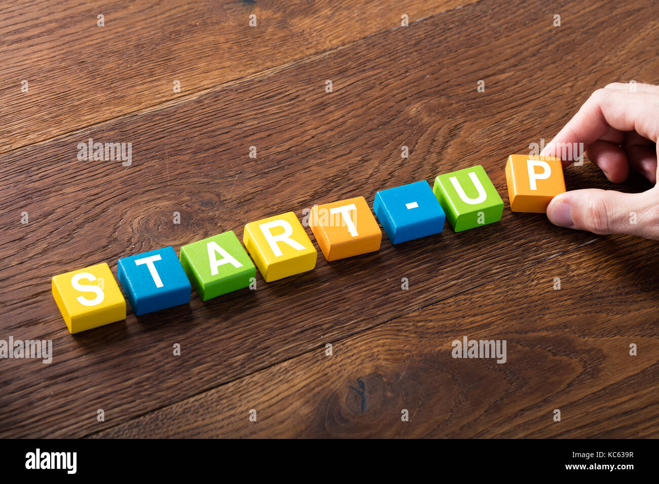Angolo di alta vista di una start-up concetto su blocchi colorati alla scrivania di legno. concetto di imprenditorialità Foto Stock