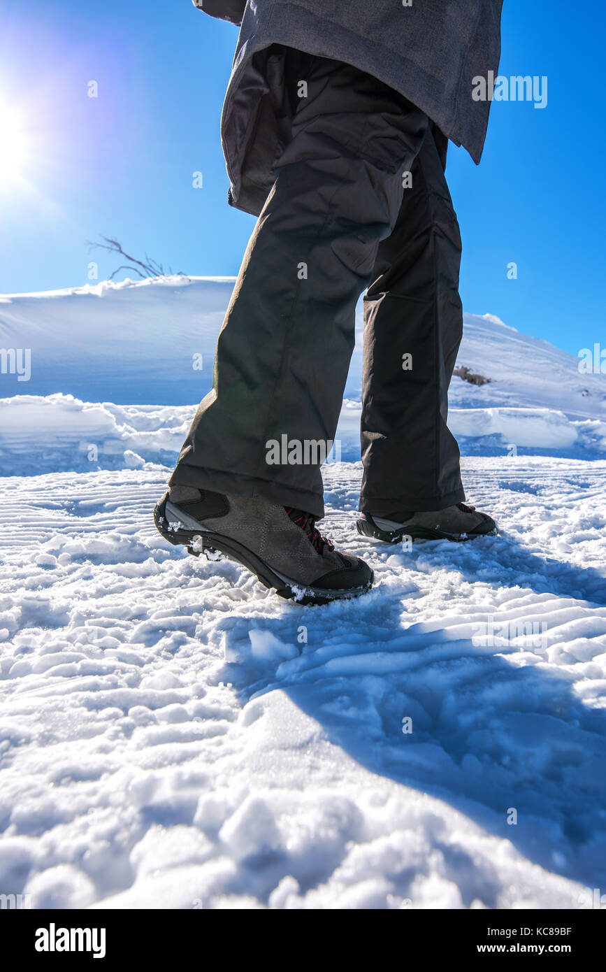 Inverno neve escursioni, donna camminando sul sentiero innevato, basso angolo di visione Foto Stock