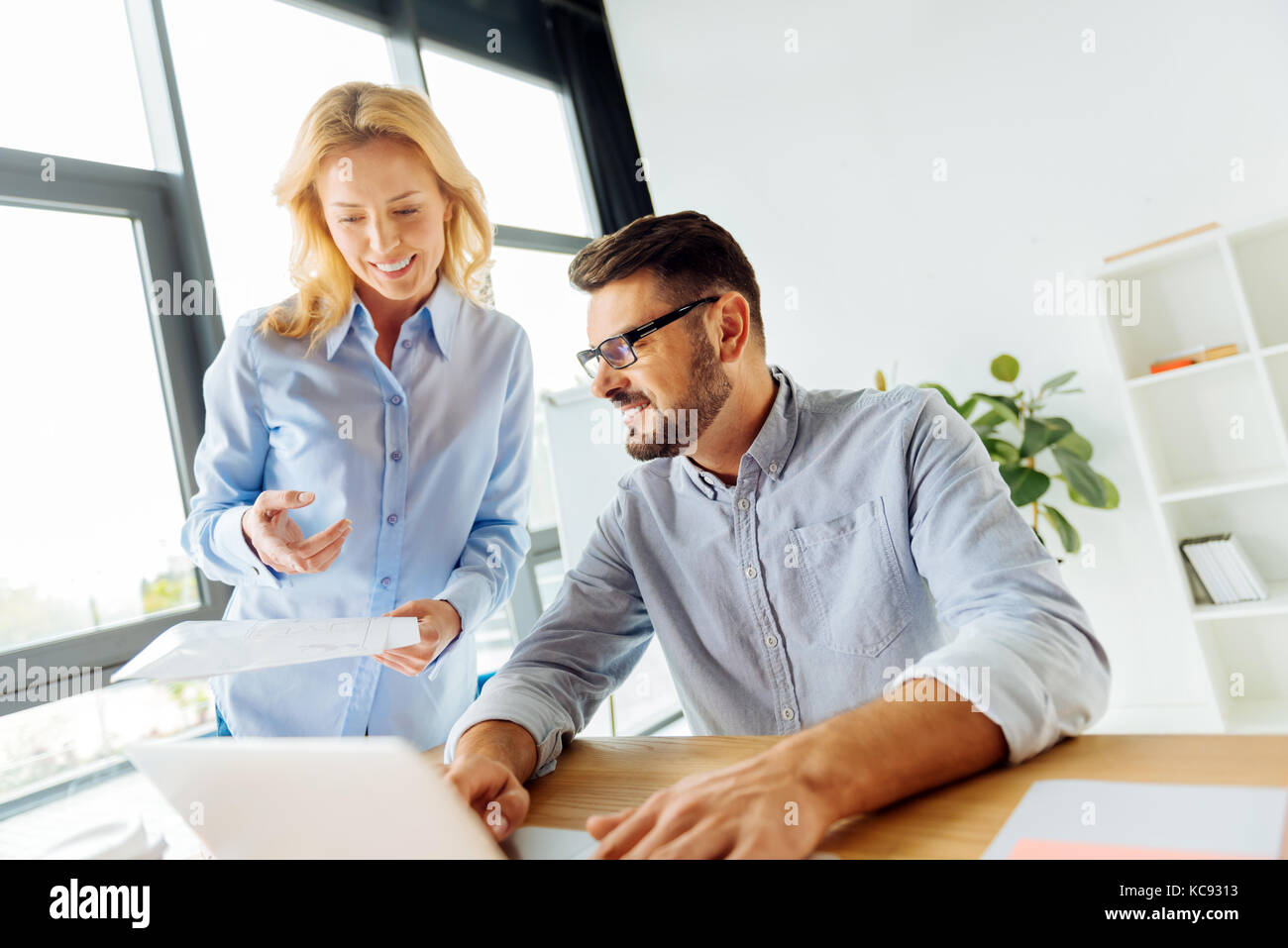 Bionda sorridente dimostrando il suo progetto Foto Stock