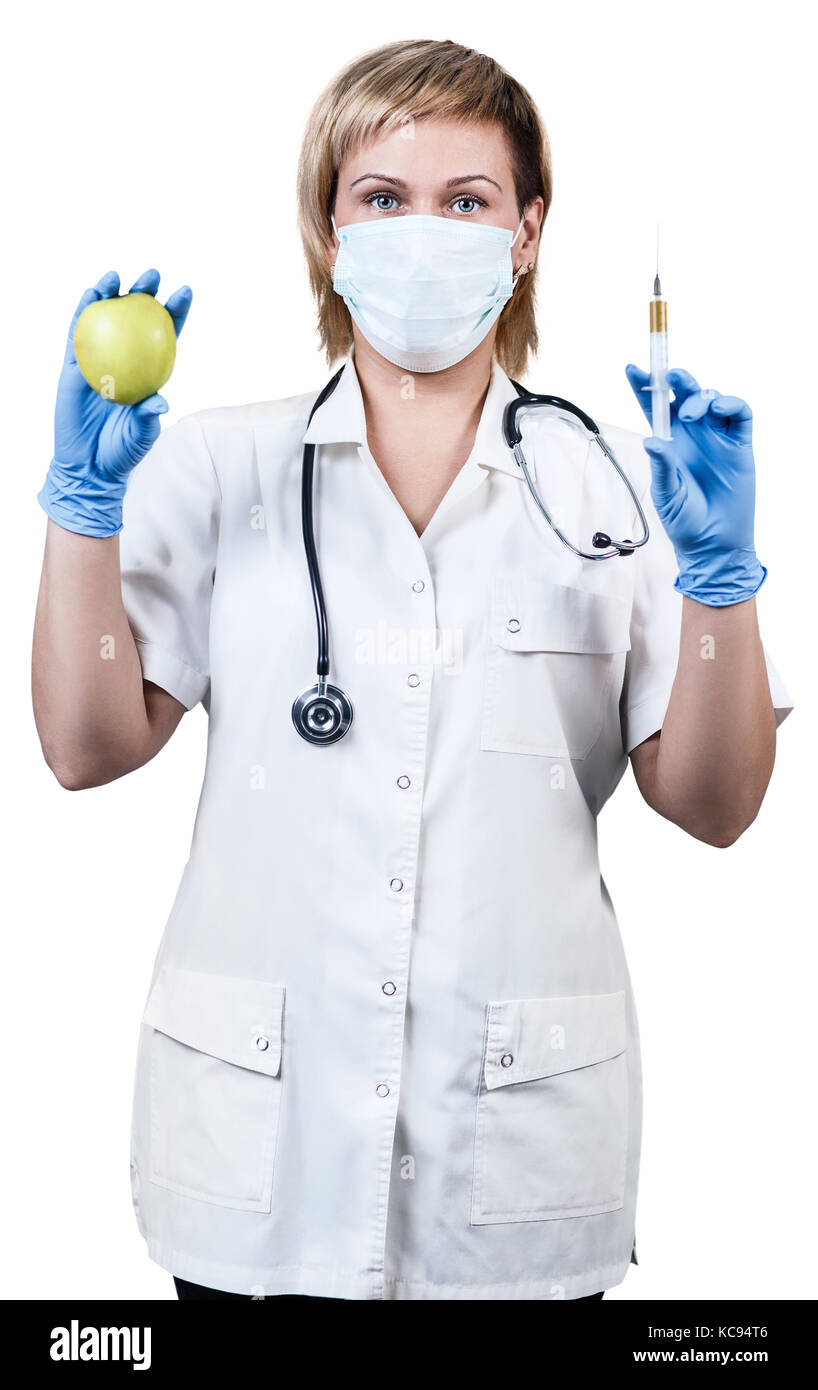 Medico donna con mela verde e la siringa. Foto Stock