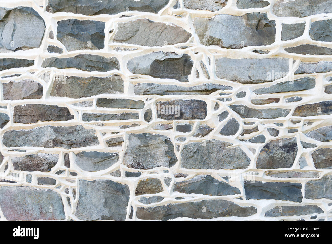 Storico muro di pietra dettaglio dal 1700 residenza sollevata con giunti in malta. Foto Stock