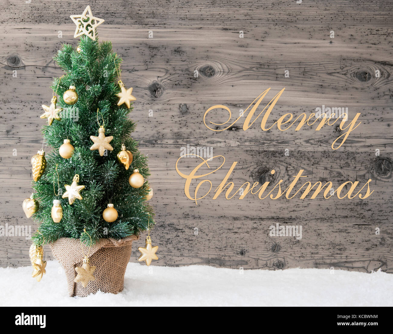 Golden albero di Natale decorato, testo buon natale Foto Stock