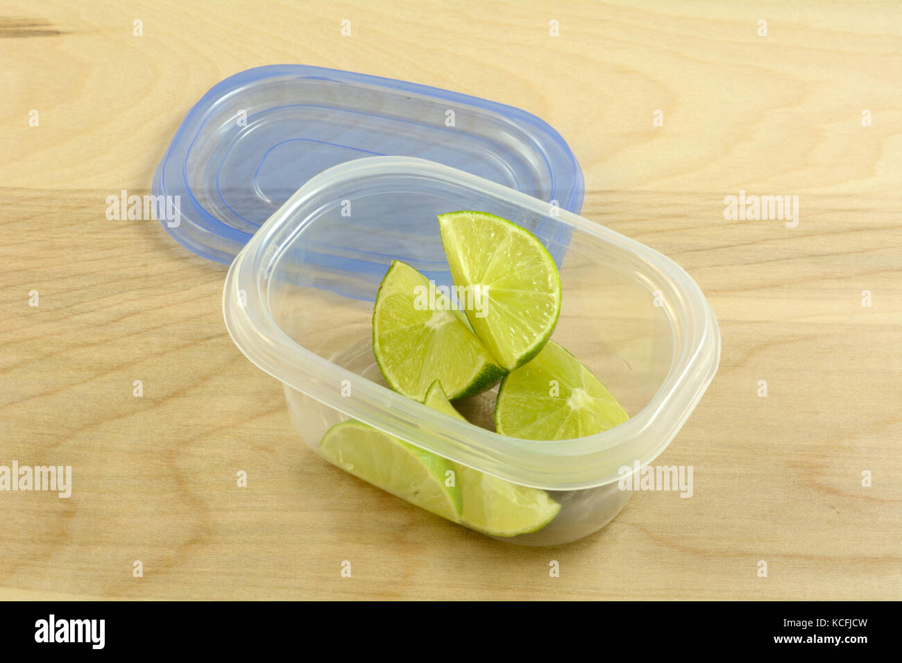 Preparare in anticipo per party con bevande o cena mettendo spicchi di lime in contenitore in plastica Foto Stock