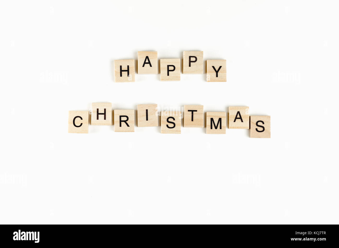 Felice Natale testo in legno su uno sfondo bianco Foto Stock