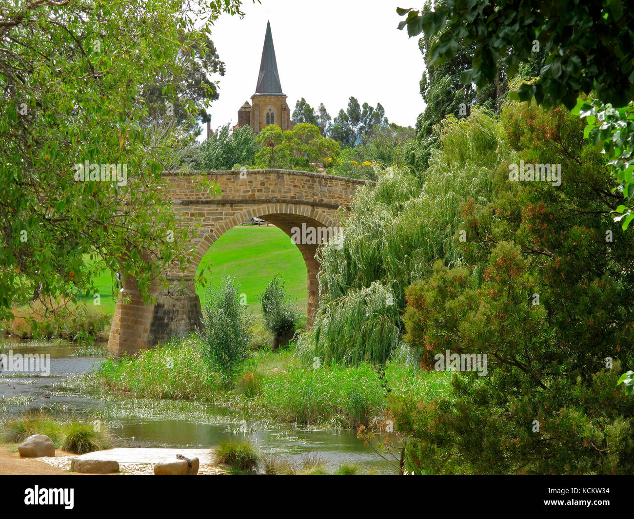 Il fiume Coal passa sotto il ponte di Richmond, con la chiesa cattolica di San Giovanni, 1837, sullo sfondo. Richmond, Tasmania, Australia Foto Stock