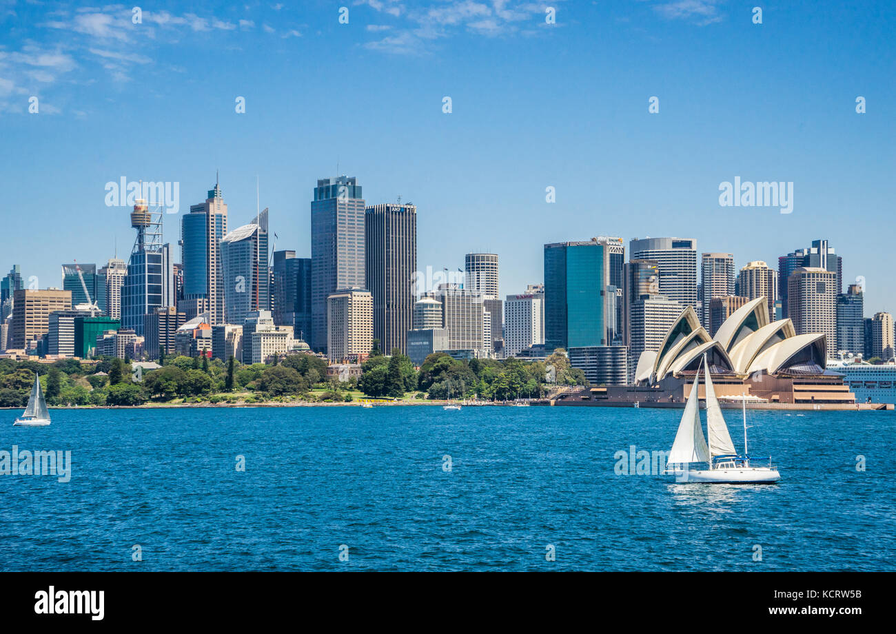 Australia, Nuovo Galles del Sud, Port Jackson, vela Sydney Harbour contro lo sfondo della Sydney Opera House, il Royal Botanic Gardens e il kit di telefonia mobile CIT Foto Stock