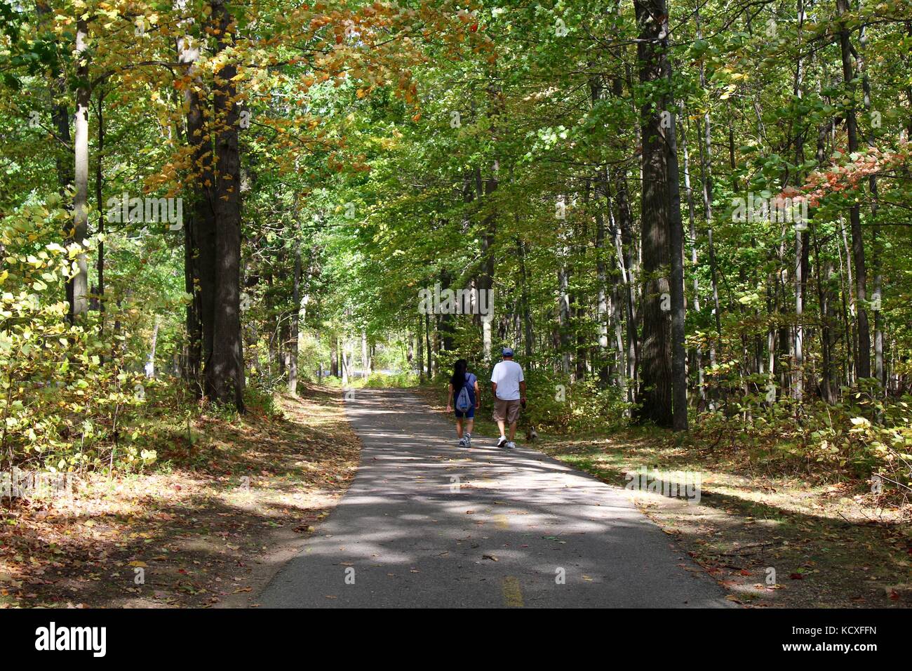 Persone che amano la giornata nel bosco su un percorso ciclabile e pedonale con la famiglia e gli amici all'aperto in un parco dove si allenano e si allenano Foto Stock