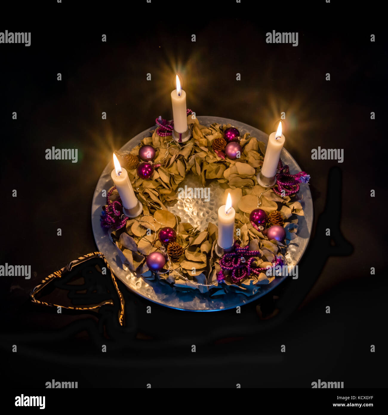Corona dell'Avvento con quattro candele su una piastra d'argento Foto Stock