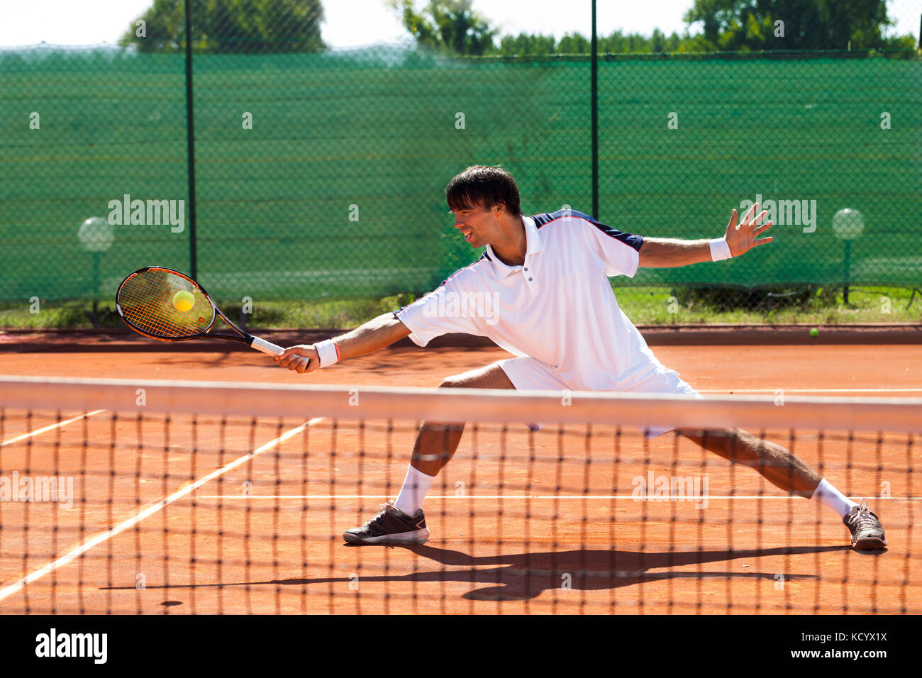 Bel giovane giocando a tennis Foto Stock