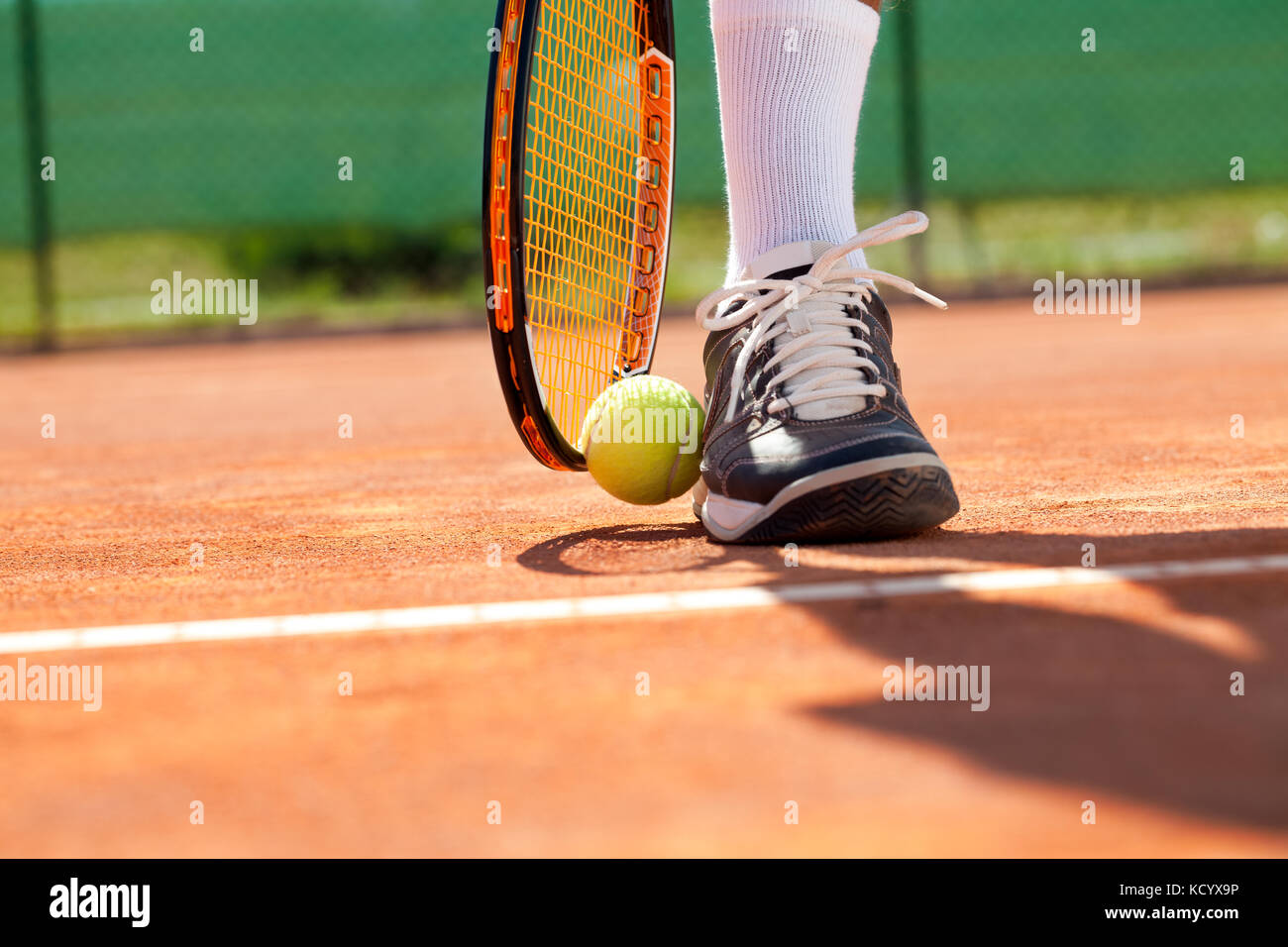 Sportsman catture fino la sua palla da tennis con la racchetta Foto Stock