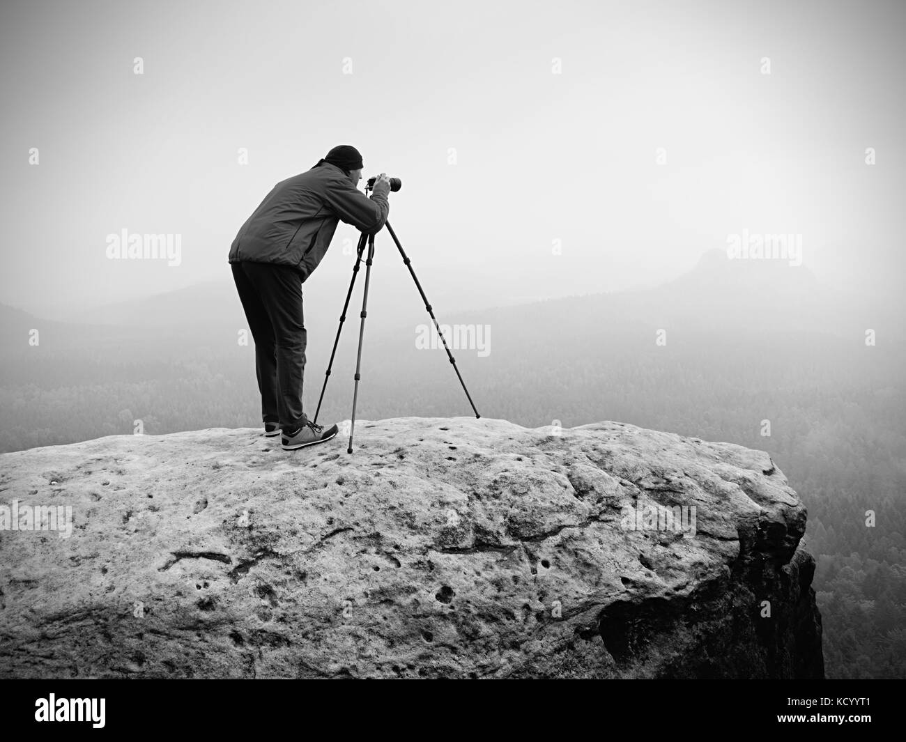 Wildlife Photographer sul vertice di montagna opere. l uomo piace viaggiare e la fotografia, scattare foto di momenti durante il tramonto autunnale in orizzontale Foto Stock